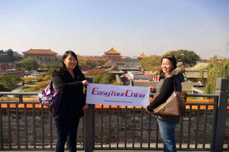 Two female travelers visit Forbidden City