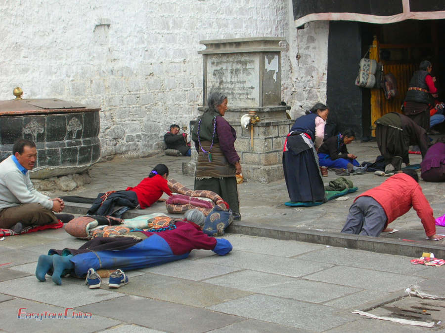 Local Tibetan people pray in front of Jokhang Temple in Lhasa