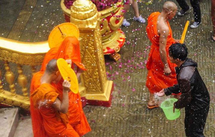 Dai people splashing water on monks