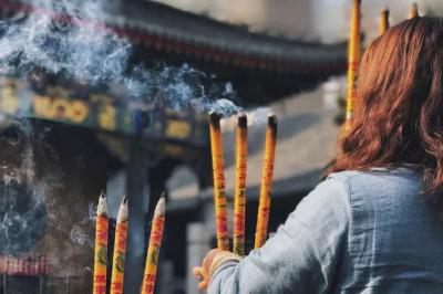 Chinese People Pray with Incense Sticks at Tai Sui Temple