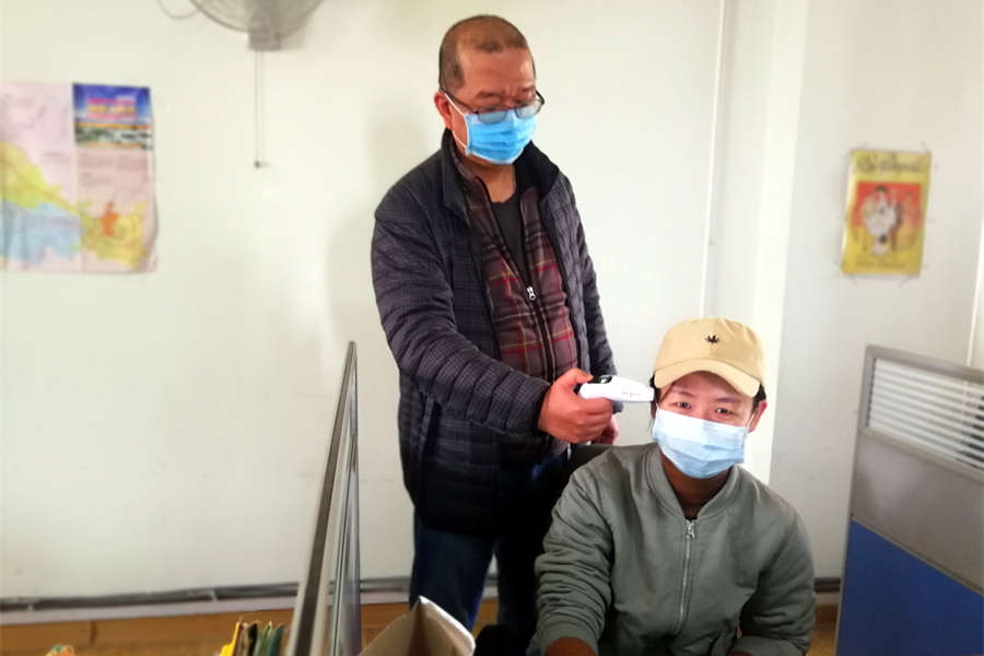 Wei and Peicy, workmates at Easy Tour China take temperature during the Coronavirus
