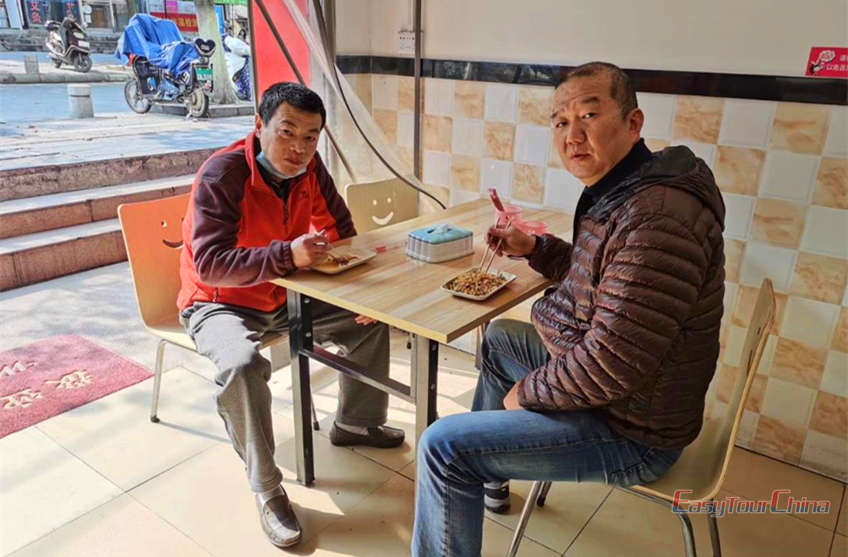 Wei and James eating in local restaurant