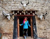 Tibetan Girl Standing front of Her Door
