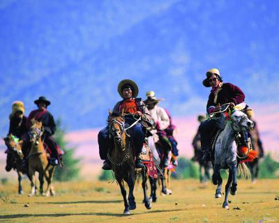 Tibetans Riding on horses in Daocheng Yading