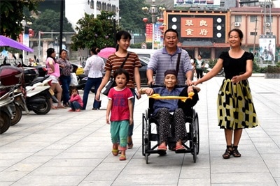 Aged parent take wheelchair to travel with family