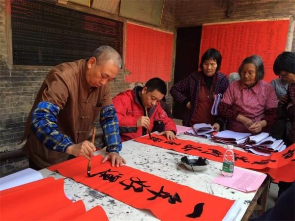 Chinese calligraphers write spring festival couplets for elders in nursing house