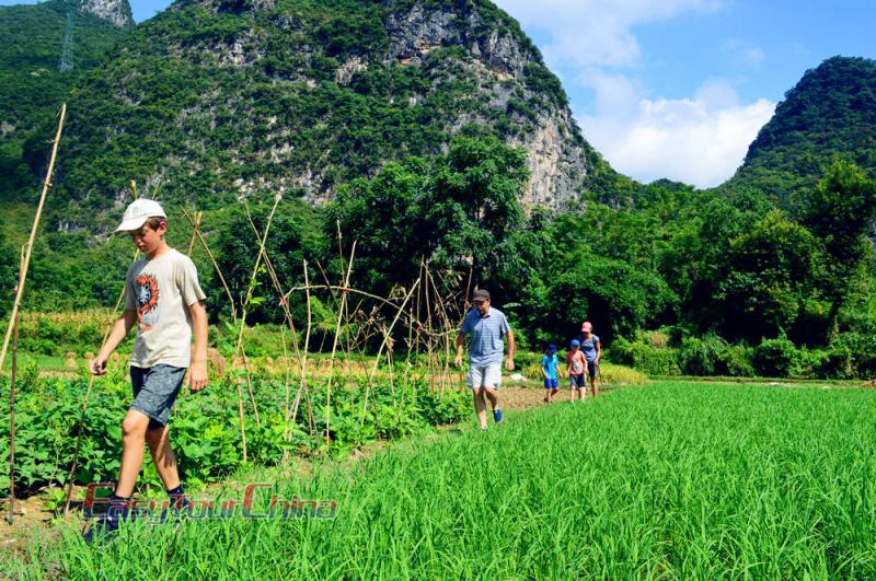 family with kids hike in the countryside of China