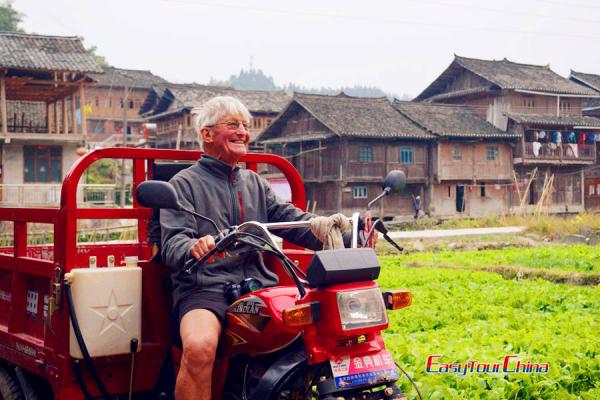 Senior traveler ride a tricycle in Guizhou