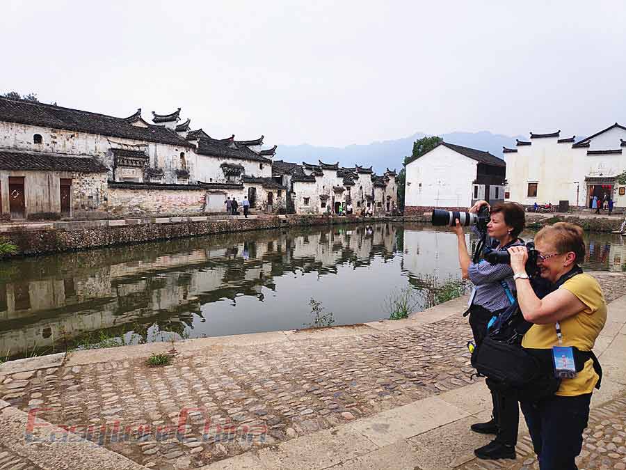 Clients shoot the beautiful black and white Huizhou architectures in Hongcun Village