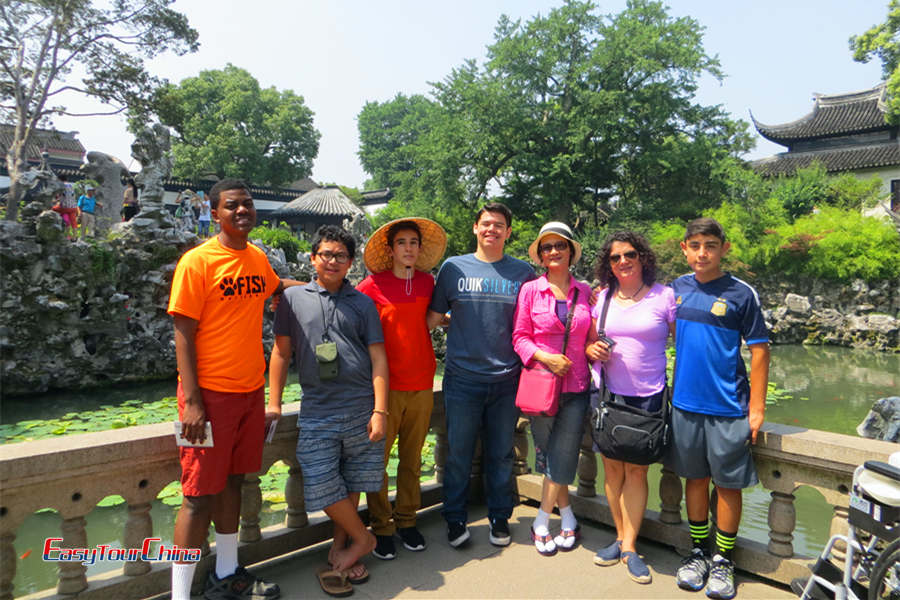 A group of students visit the Yu Garden in summer