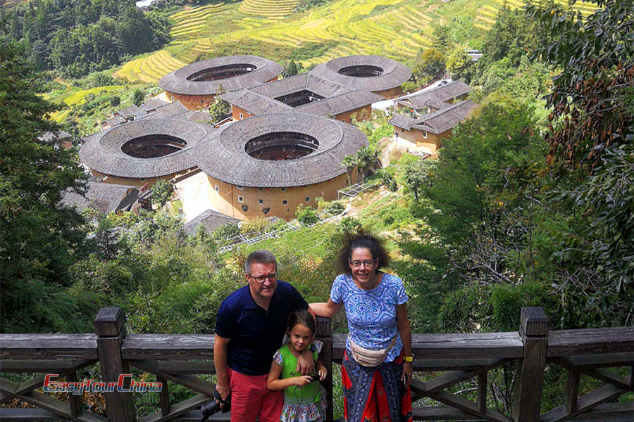 Parents with daughter visit Tianluokeng Earth Towers (Tulou)