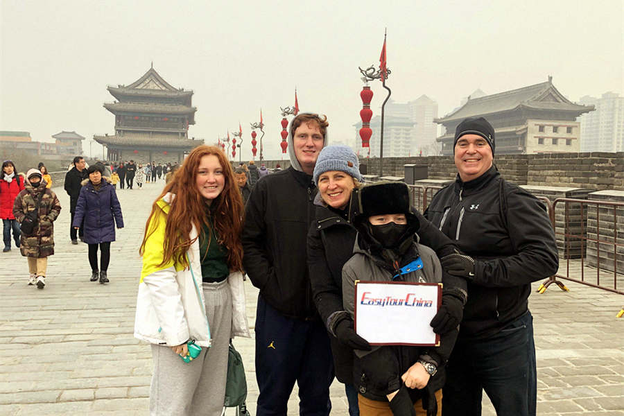 A family with kids visit the Ancient City wall of Xian