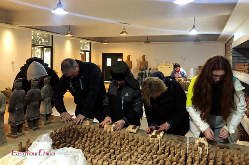 Family with chidren make mini warrior in Xian