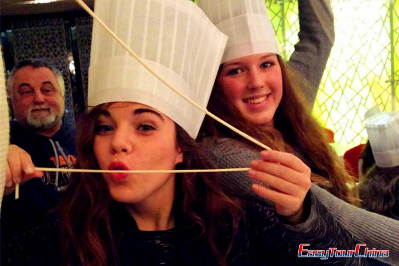 Teens make Chinese noodles in Xian